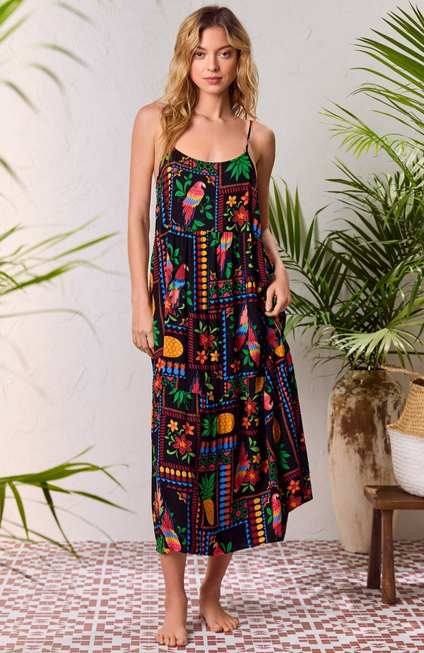 A lady wearing black short sleeve Sara Maxi Chemise with Tropical Fiesta print.