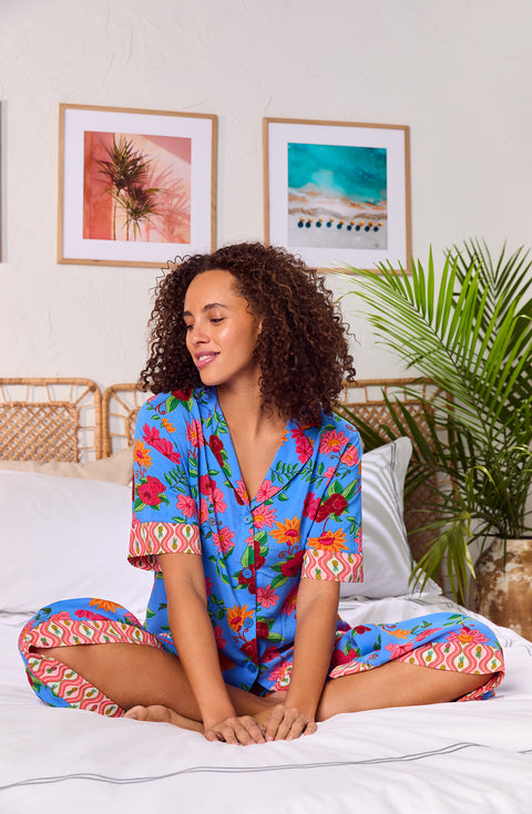 A lady wearing blue short sleeve Georgia Cropped Pj Set with Island Floral print.