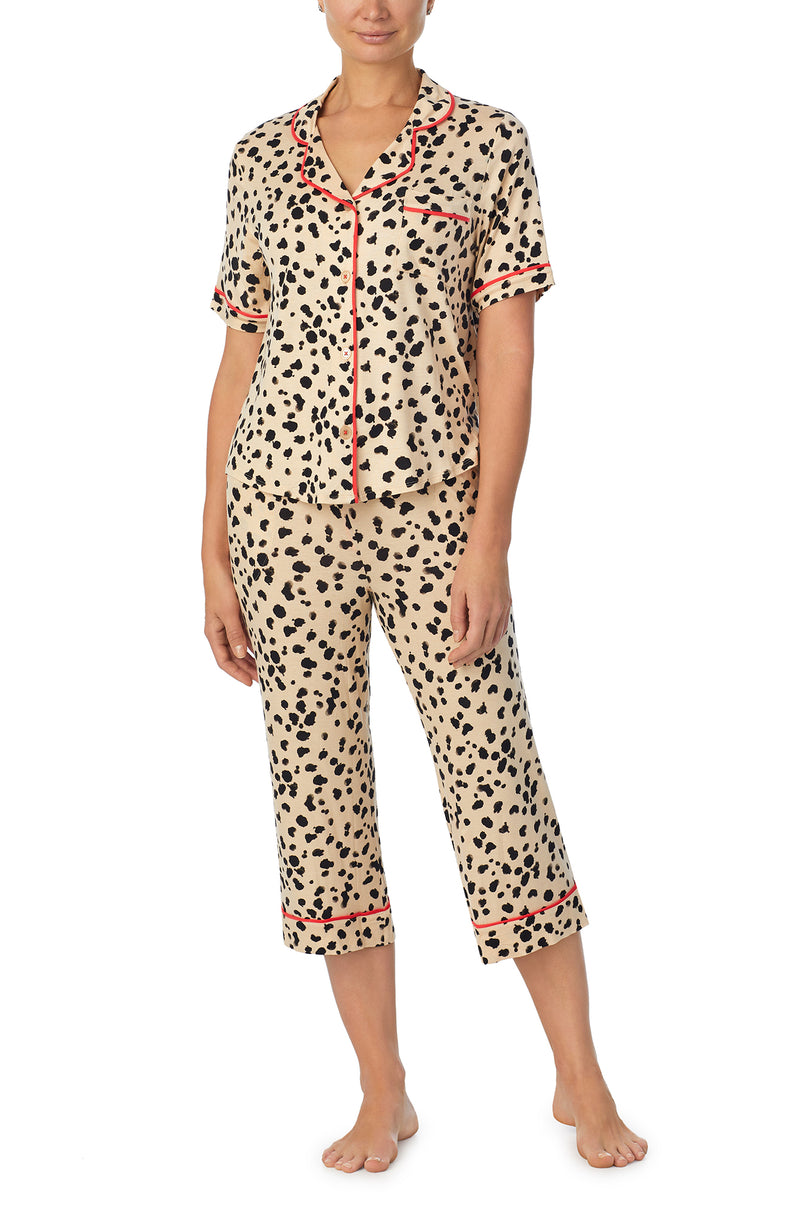 A lady wearing tan short sleeve teagan pj set with desert dots print.