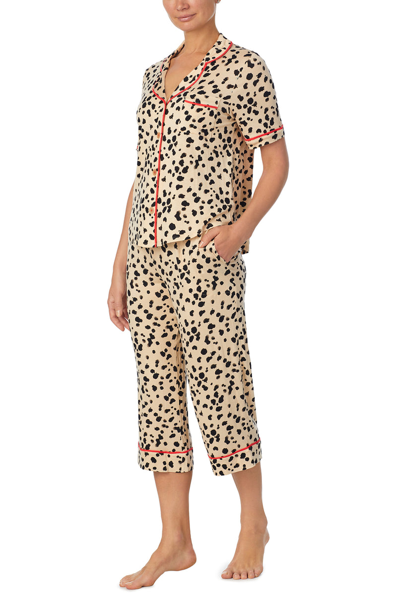 A lady wearing tan short sleeve teagan pj set with desert dots print.