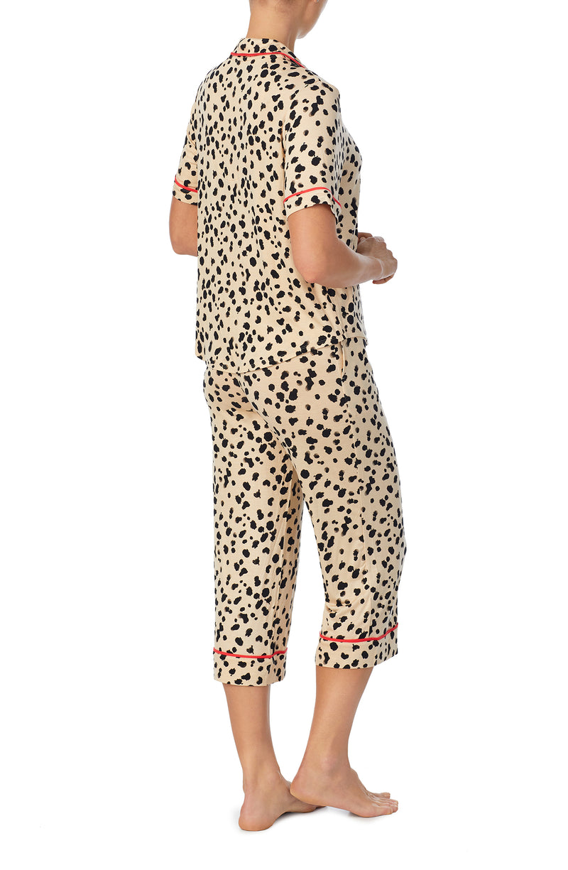 A lady wearing tan short sleeve teagan pj set with desert dots print.