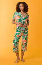 A lady wearing pink short sleeve Soho Pj Set withSunset Safari print.