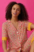 A lady wearing pink short sleeve Georgia Cropped Pj Set with Pineapple Pop print.