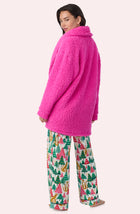 A Lady Wearing Blake Sherpa Short Jacket In Holly Jolly Pink in a back view pose