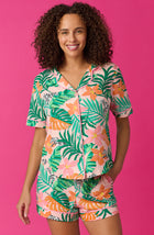A lady wearing pink short sleeve Brooklyn Pj Set with sunset safari print.