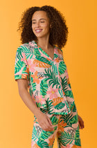 A lady wearing pink short sleeve Soho Pj Set withSunset Safari print.