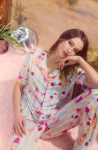 A Lady Wearing Dakota Long Knit Pj Set In Bottle Service in a sitting pose while placed her hand at the chin