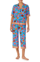 A lady wearing blue short sleeve Georgia Cropped Pj Set with Island Floral print.