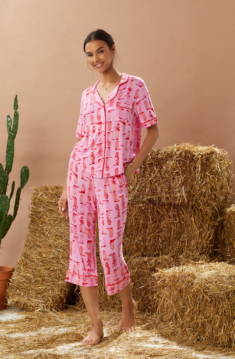 A lady wearing pink short sleeve teagan pj set with blushing cowgirl.