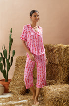 A lady wearing pink short sleeve teagan pj set with blushing cowgirl.
