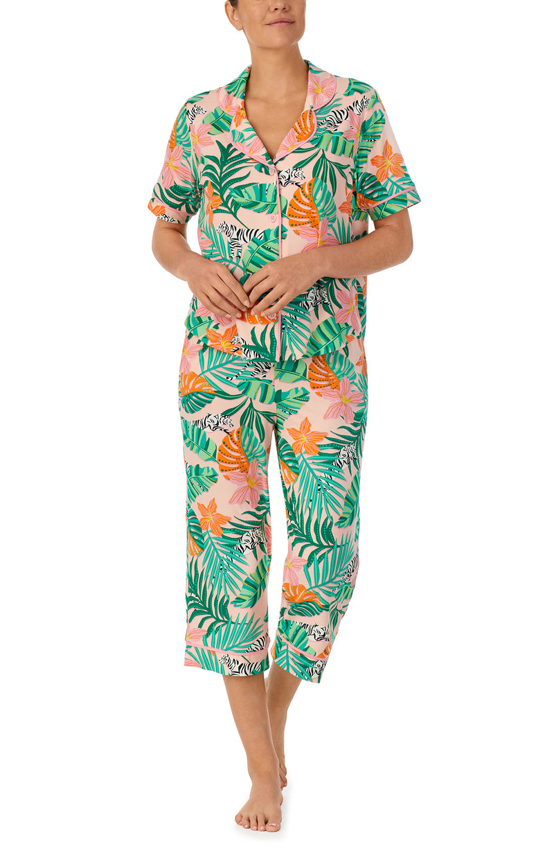 A lady wearing pink short sleeve Soho Pj Set withSunset Safari print.