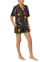 A lady wearing black short sleeve Georgia Short Pj Set with Tropical Fiesta print.