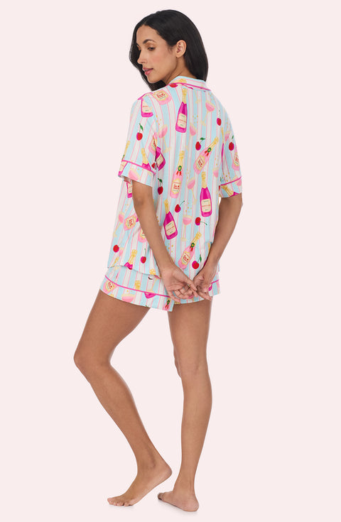 A Lady Wearing Dakota Short Knit Pj Set In Bottle Service in a back view pose while looking to the side