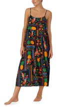 A lady wearing black short sleeve Sara Maxi Chemise with Tropical Fiesta print.