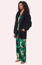 A Lady Wearing Blake Sherpa Short Jacket In Black in a side angle pose