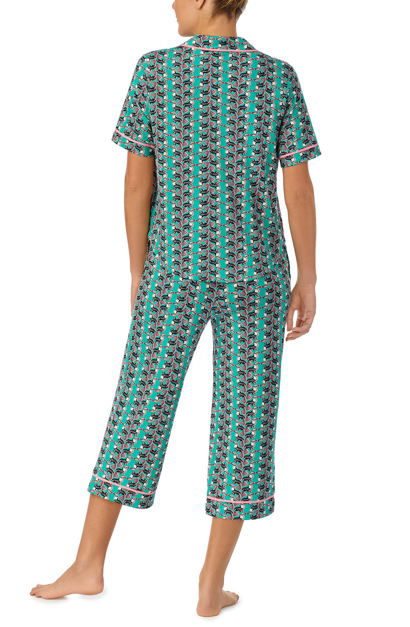 A lady wearing green short sleeve Soho Pj Set with Tucan Tango print.