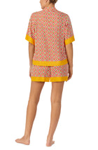 A lady wearing pink short sleeve Georgia Short Pj Set with Pineapple Pop print.