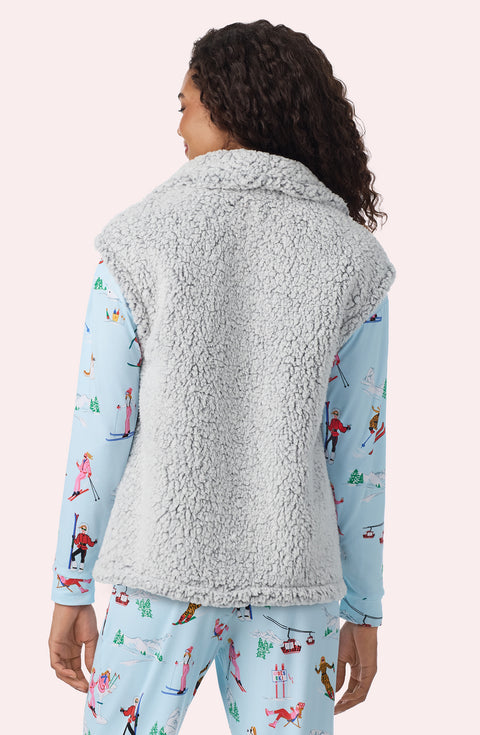 A Lady Wearing Tessa Sherpa Vest In Frosted Slate in a closer look, back view pose