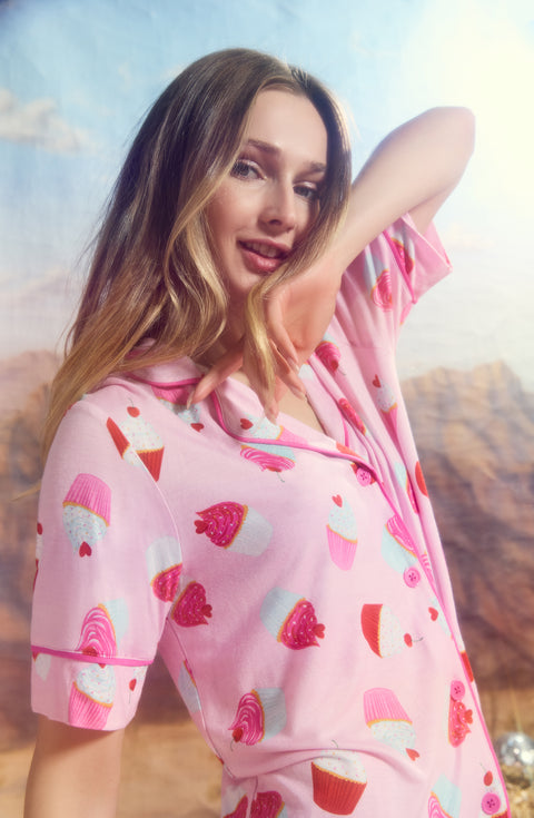 A Lady Wearing Dakota Short Knit Pj Set In Cherry On Top posed in a side profile with one hand raised near her face