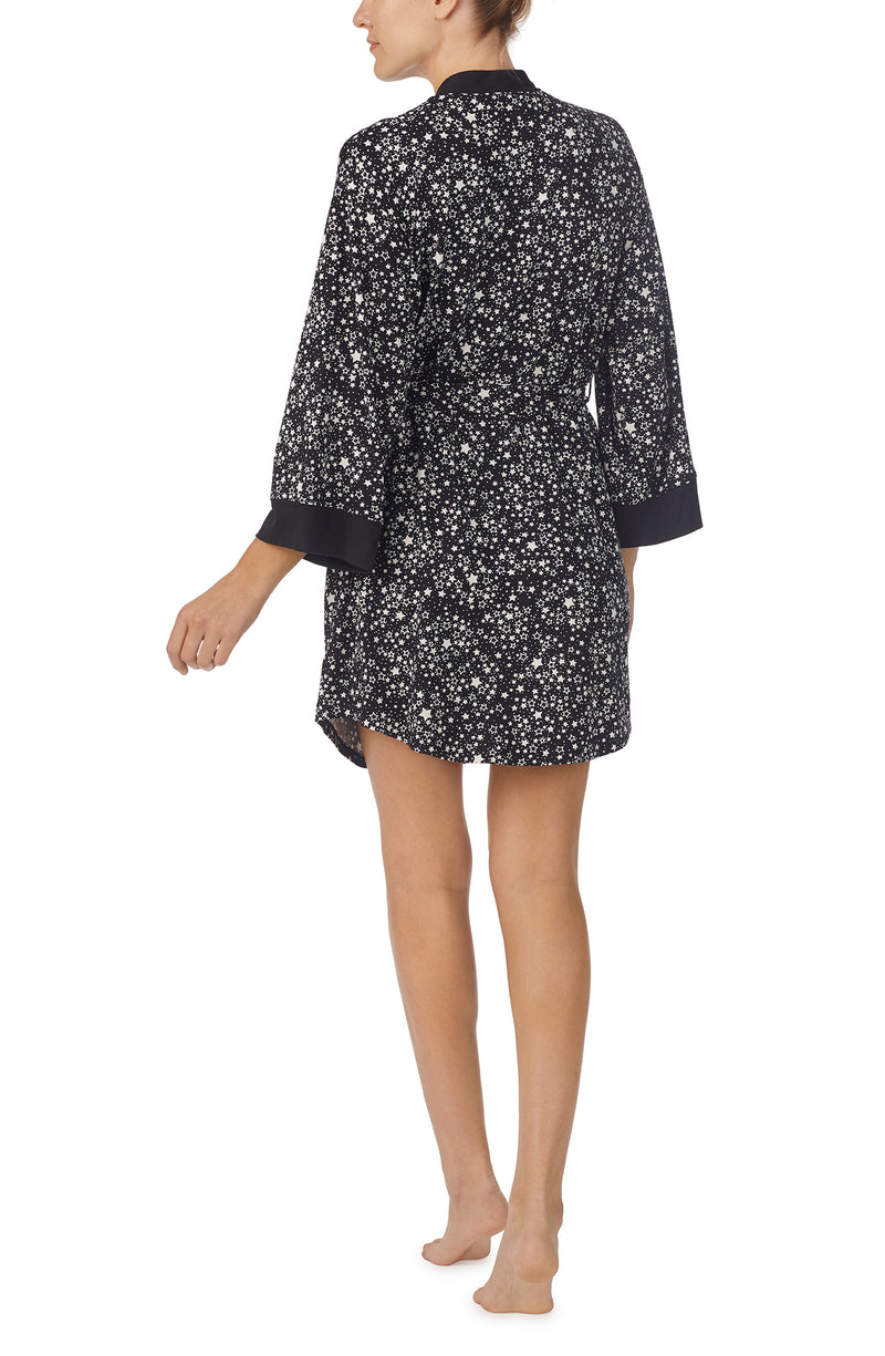 A lady wearing black quarter sleeve Nadia Robe with Midnight Sky print.