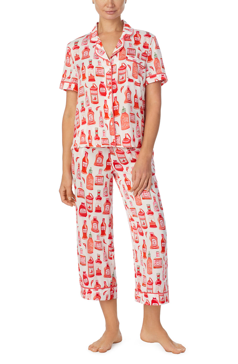 A lady wearing white short sleeve chelsea pj set with hot stuff print.