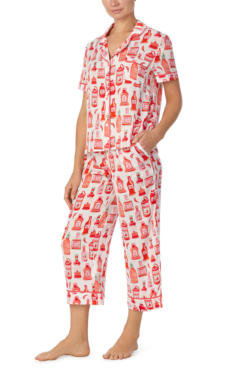A lady wearing white short sleeve chelsea pj set with hot stuff print.