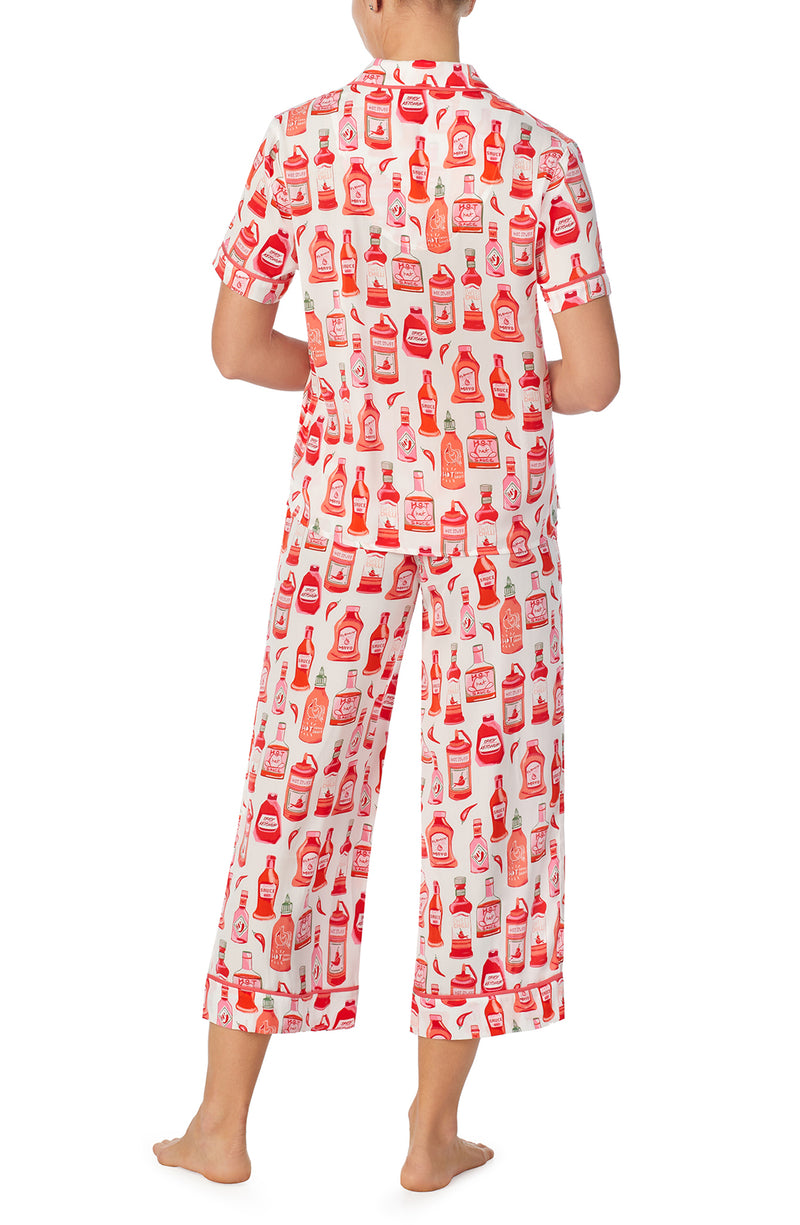 A lady wearing white short sleeve chelsea pj set with hot stuff print.