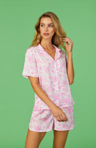 A lady wearing pink short sleeve florence pj set in Sweetheart Floral with flowers print.