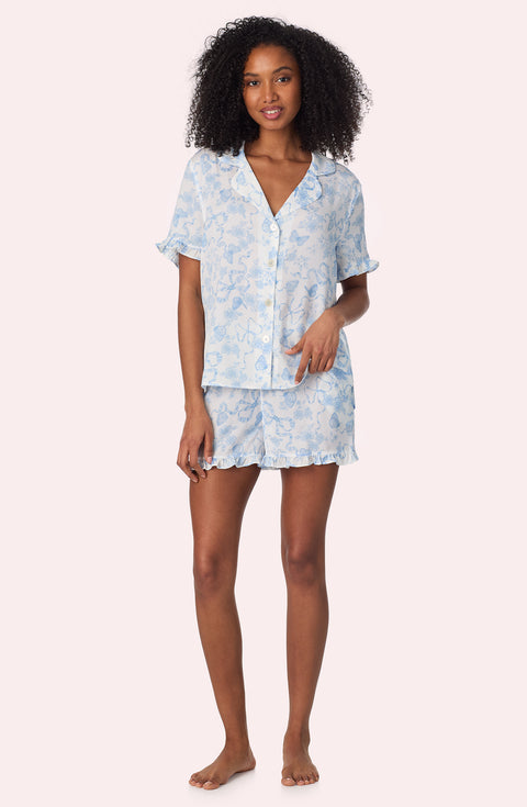 A lady wearing Nia Short Woven Pj Set In Butterflies & Bows