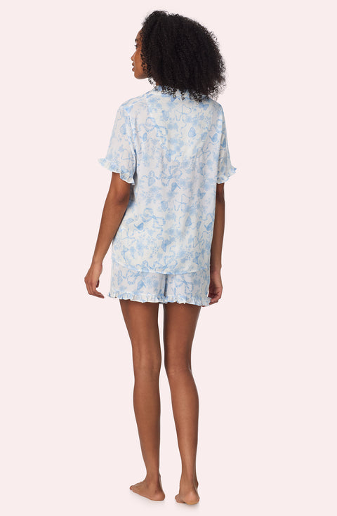 A lady wearing Nia Short Woven Pj Set In Butterflies & Bows