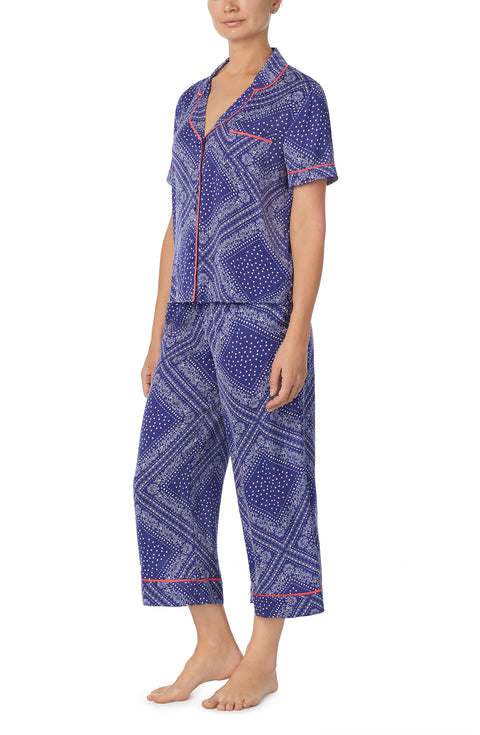 A lady wearing blue short sleeve chelsea pj set with bandana babe print.