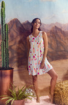 A Lady Wearing Kellie Knit Chemise In Bottle Service standing against a mountain themed wallpaper