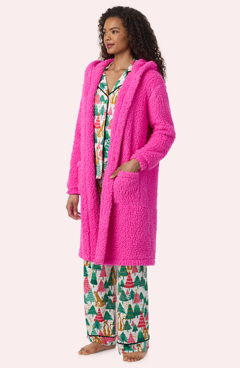 A Lady Wearing Maisie Sherpa Long Jacket In Holly Jolly Pink in a front view, side angle pose