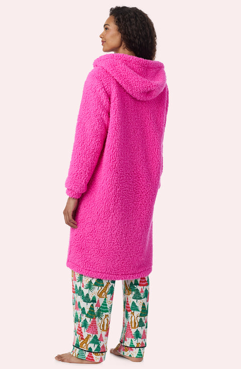 A Lady Wearing Maisie Sherpa Long Jacket In Holly Jolly Pink posing from the back while looking to the side