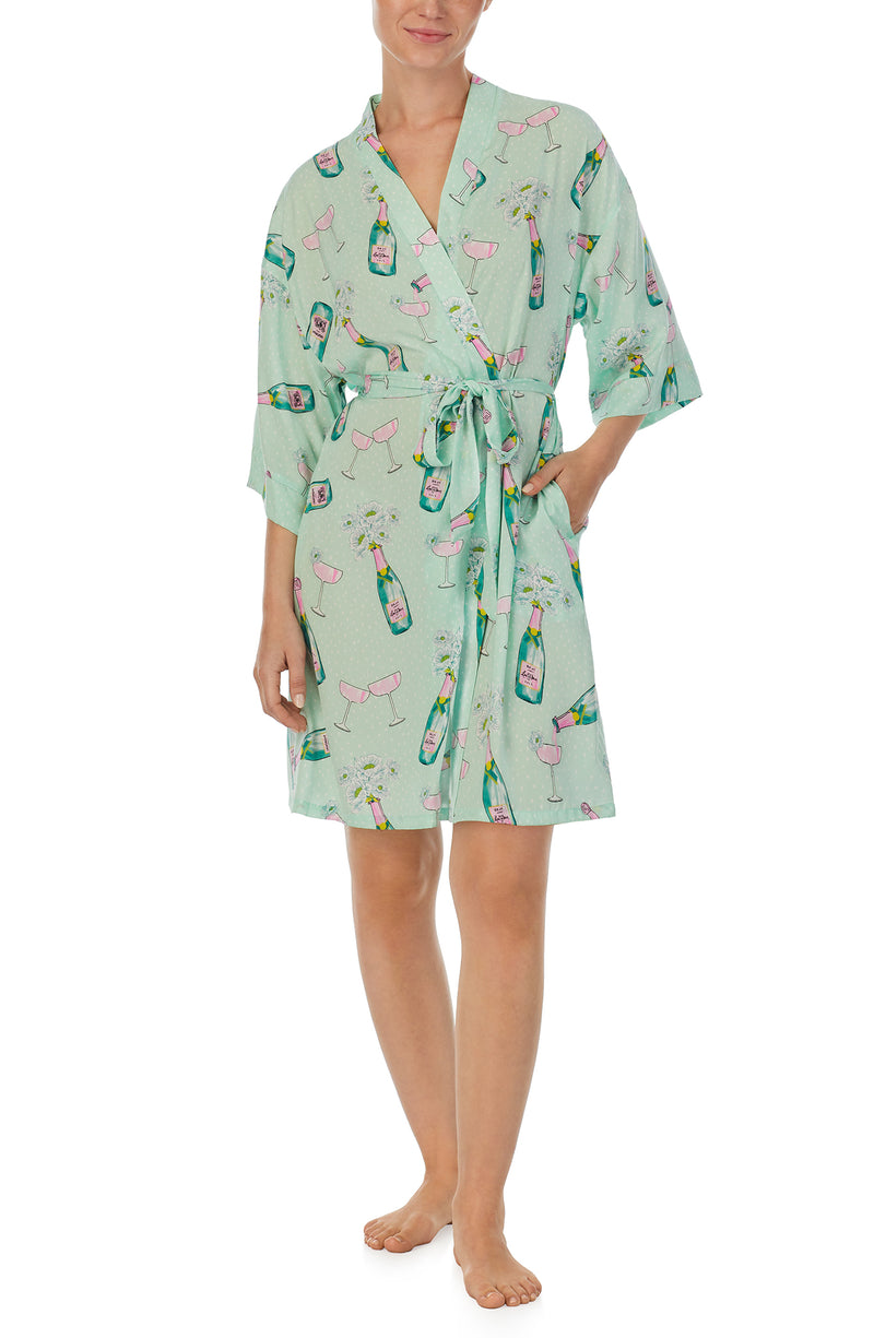 A lady wearing green short sleeve Sierra Robe In Bubbly Blossoms