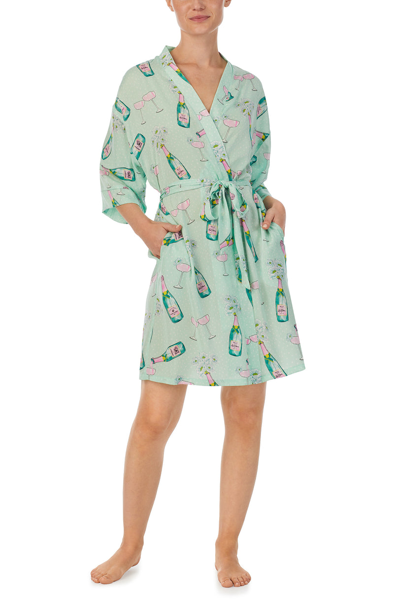 A lady wearing green short sleeve Sierra Robe In Bubbly Blossoms