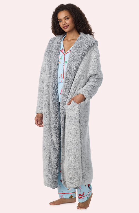 A Lady Wearing Aubrie Sherpa Long Jacket In Frosted Slate in a front facing side angle pose