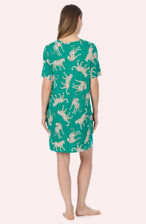 A Lady Wearing Mila Knit Sleepshirt In Safari Spots in a back view standing pose