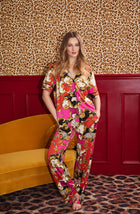 A Lady Wearing Sienna Long Knit Pj Set In Cheetah Chic in a front view standing pose against a leopard background