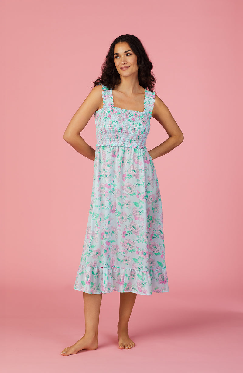 A lady wearing blue sleeveless Willow Chemise In Vines And Vows with flowers print