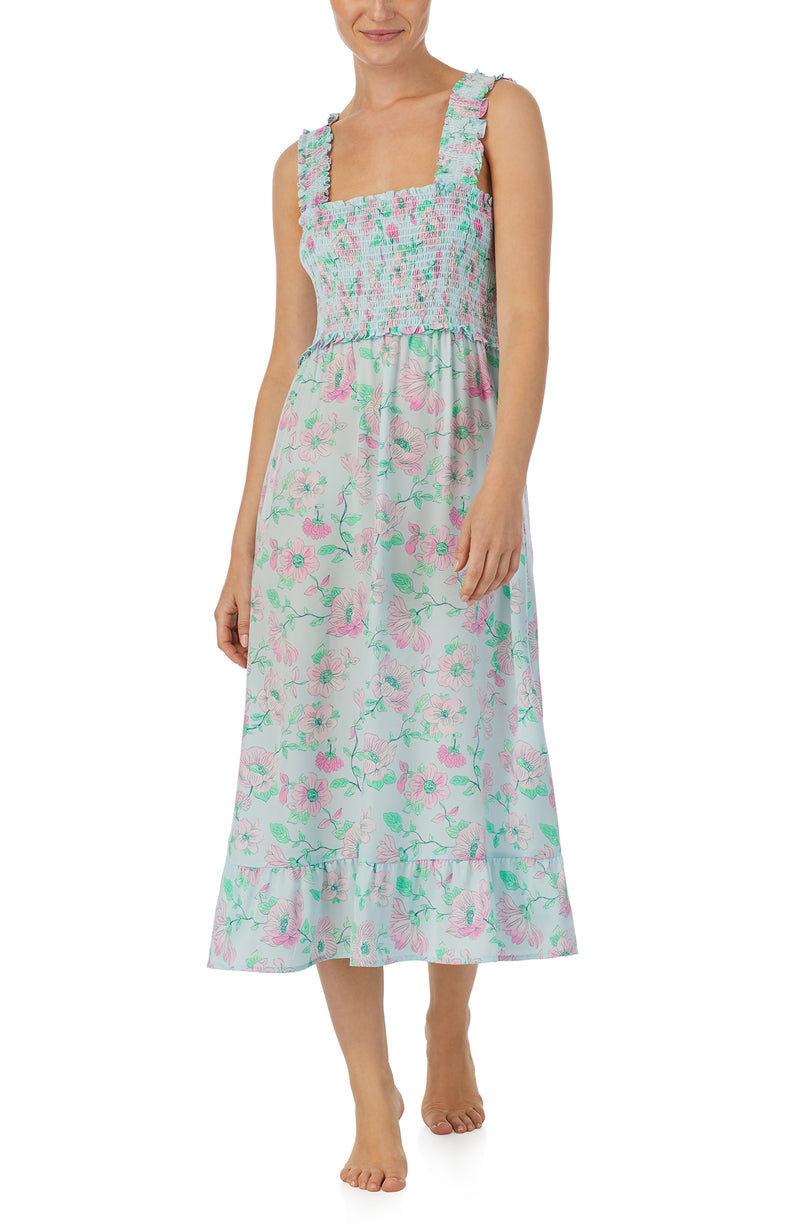 A lady wearing blue sleeveless Willow Chemise In Vines And Vows with flowers print