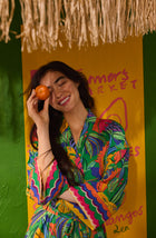 A Lady Wearing Cara Woven Robe In Jungle Breeze