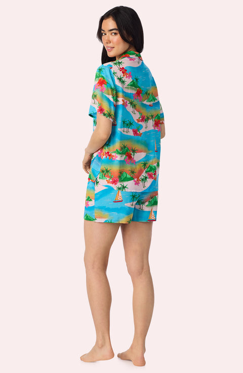 A Lady Wearing Amelia Short Woven Pj Set In Sunset Escape posing back view