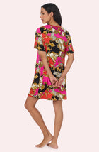 A Lady Wearing Sammi Knit Sleepshirt In Cheetah Chic in a back view pose
