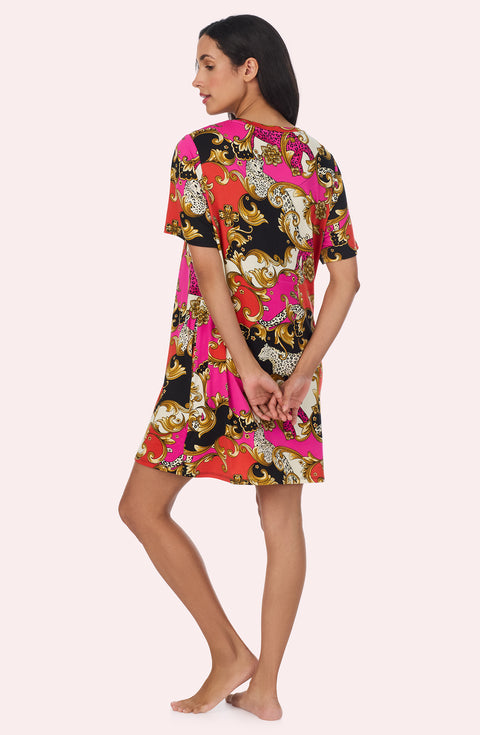 A Lady Wearing Sammi Knit Sleepshirt In Cheetah Chic in a back view pose