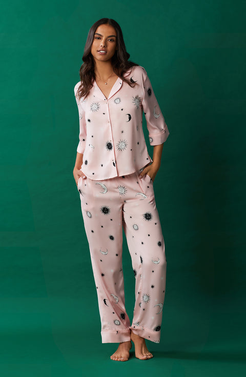 A lady wearing pink quarter sleeve gramercy pj set with over the moon print.