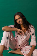 A lady wearing pink quarter sleeve gramercy pj set with over the moon print.