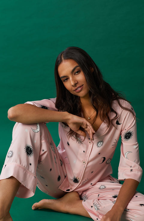 A lady wearing pink quarter sleeve gramercy pj set with over the moon print.