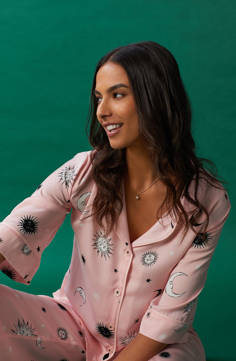A lady wearing pink quarter sleeve gramercy pj set with over the moon print.