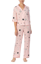 A lady wearing pink quarter sleeve gramercy pj set with over the moon print.